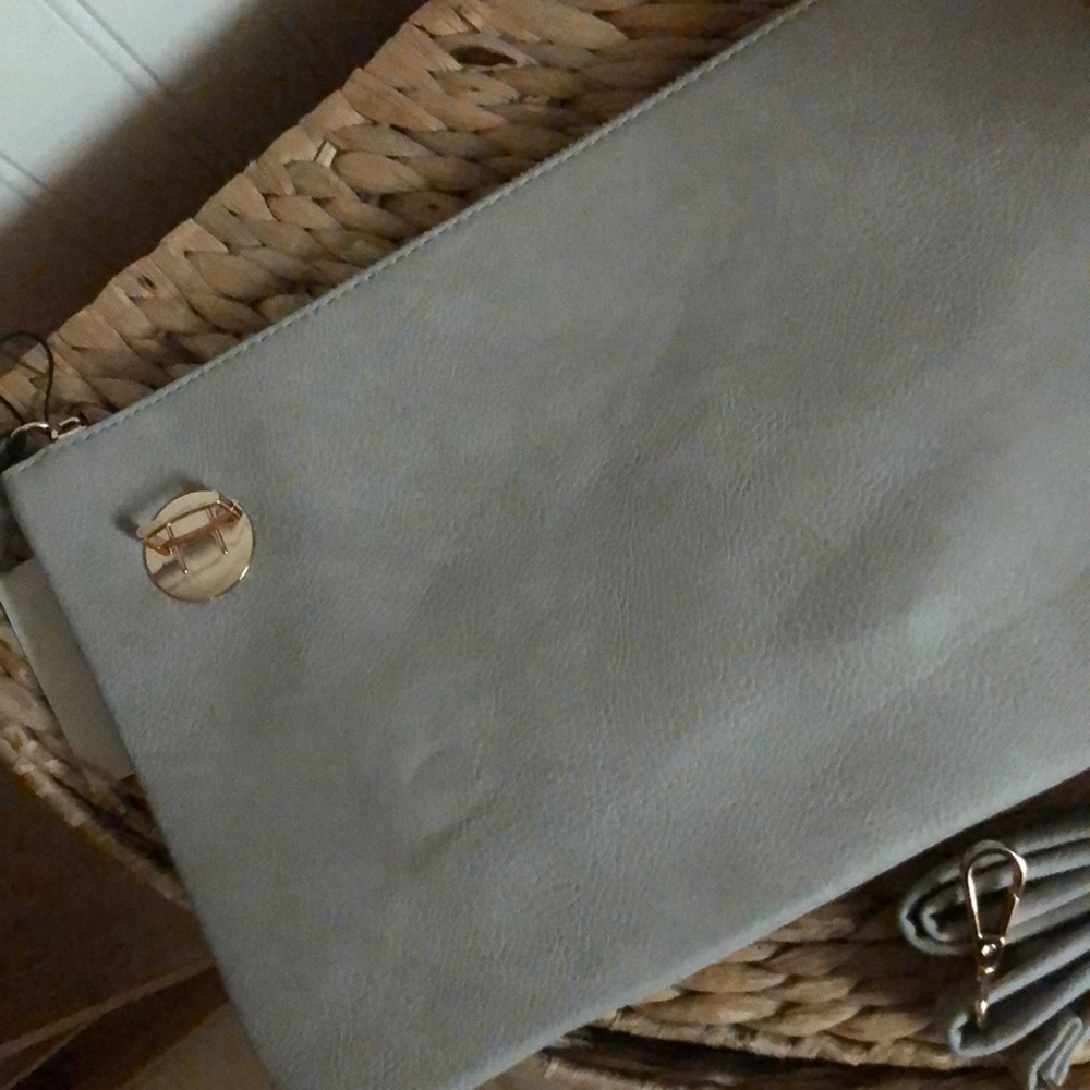New with tags grey purse clutch with strap.